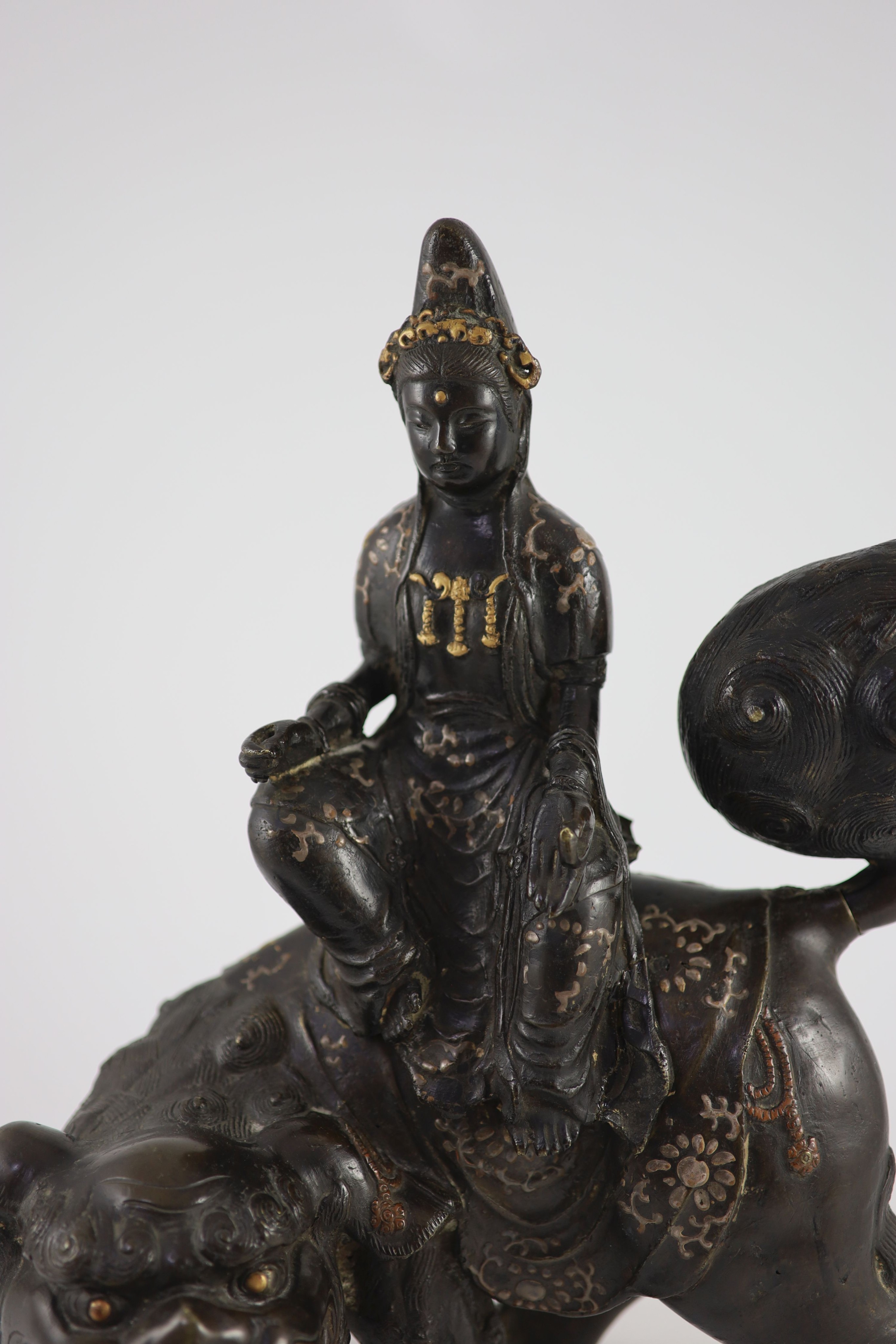 A large Chinese/Japanese bronze censer modelled as Wenshu riding a lion-dog, 17th/18th century 40 cm high, 35 cm long
